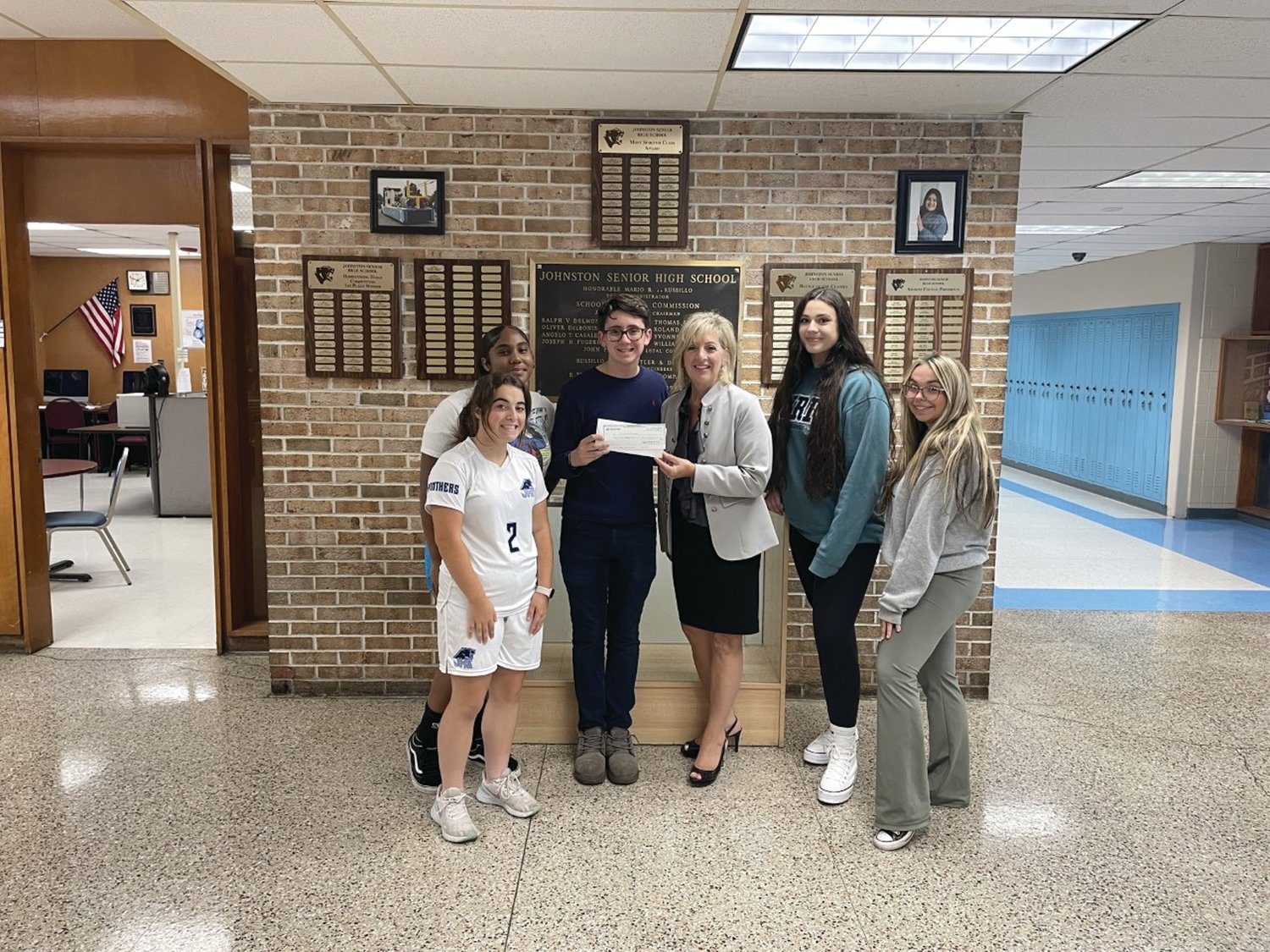 GENEROUS GIFT: Lisa Abbenante, Executive of The Tomorrow Fund that’s based at Hasbro Children’s Hospital, accepts a $945 check from JHS Student Council President Charles Curci that will be used to help families whose children are battling cancer. Also taking part were Josephine Olagundoye, Alessandra Presare and Lucas Anderson.